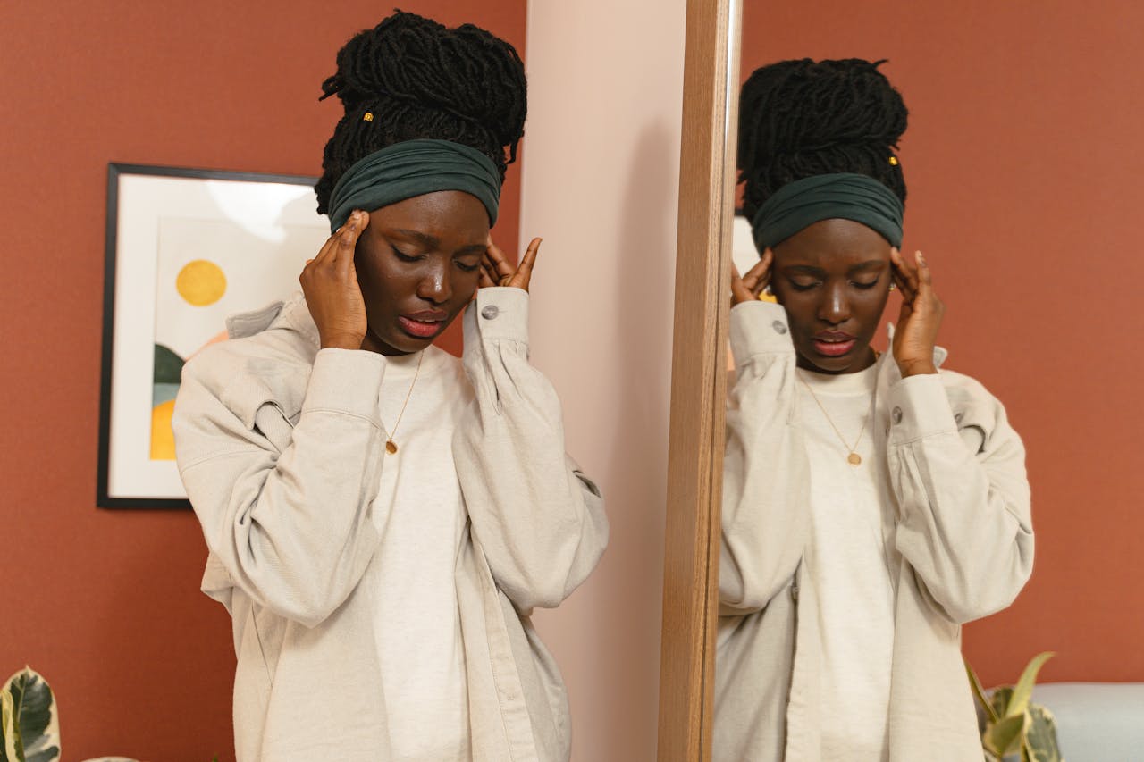 Young Woman Touching Her Temples from a Headache